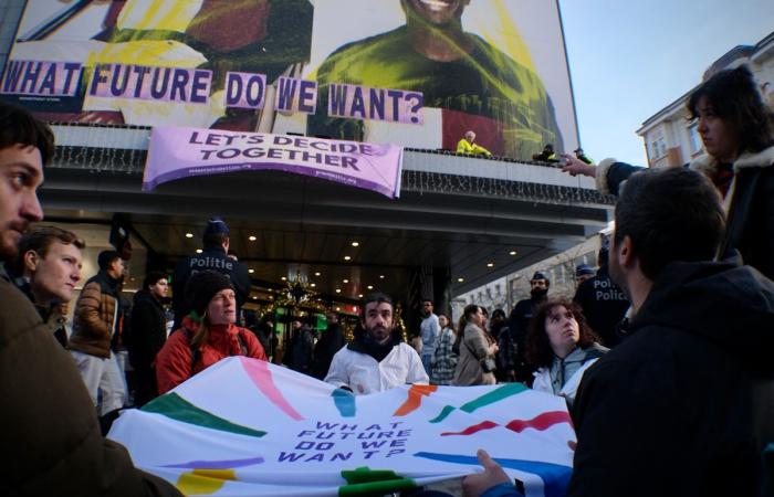 “Che futuro vogliamo”? Attivisti sventolano uno striscione all’Inno di rue Neuve per denunciare il consumo eccessivo durante il Black Friday (FOTO)